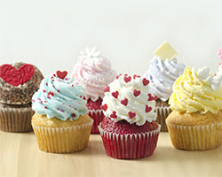 Red, yellow, brown cupcakes with various coloured icing and toppings